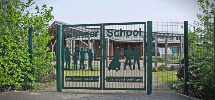 A student draws a fence with several gates